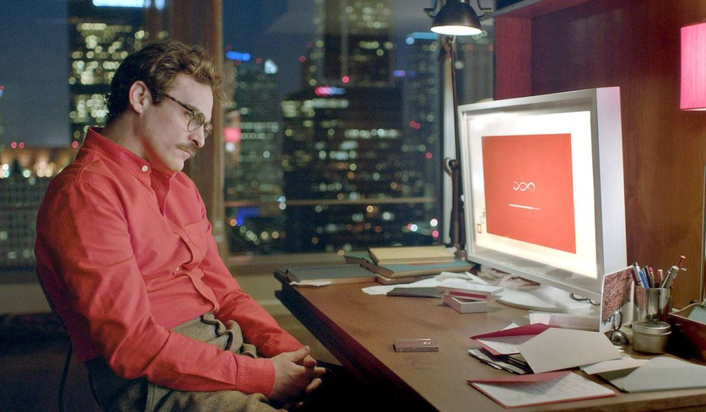 Still from the movie Her with a man in a red shirt looking at a computer screen
