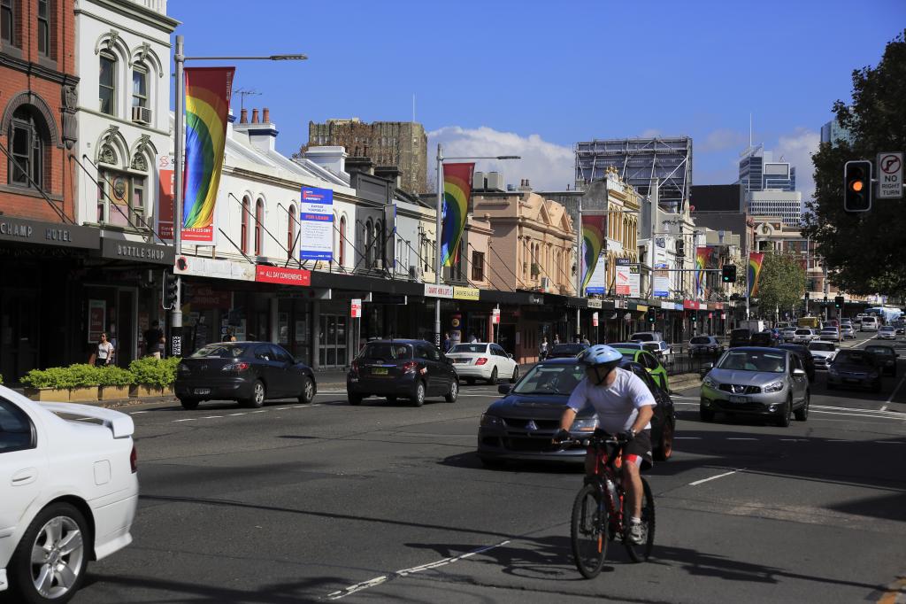 Cyclist biking on the road, Oxford Street, Paddington, in Sydney Australia.